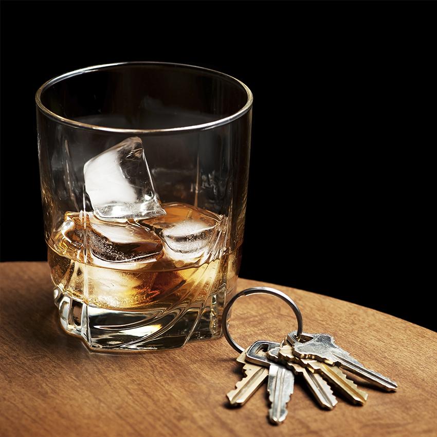 glass of whiskey next to car keys