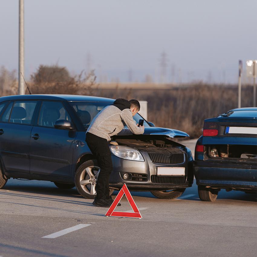 man documenting car accident with smartphone