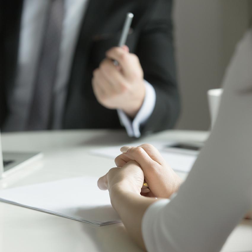 man in suit talking with nervous woman