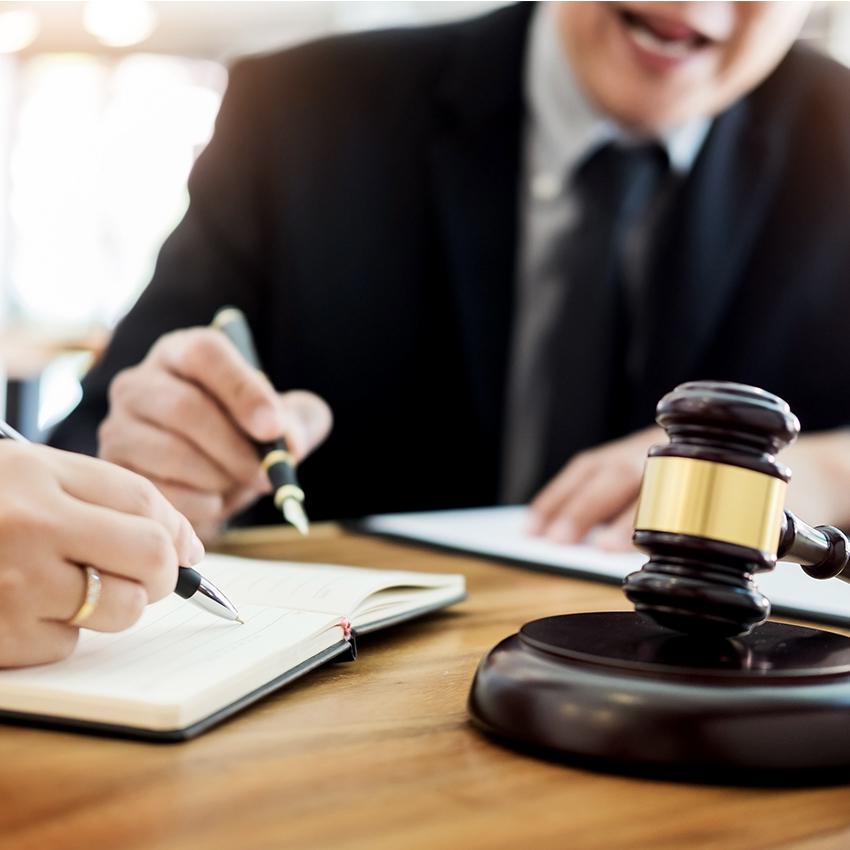 gavel and people reviewing papers