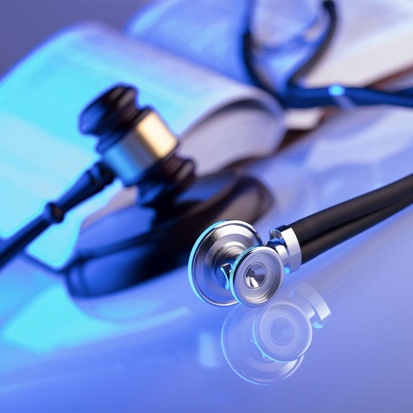 gavel and stethoscope on desk